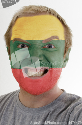 Image of Face of crazy angry man painted in colors of lithuania flag