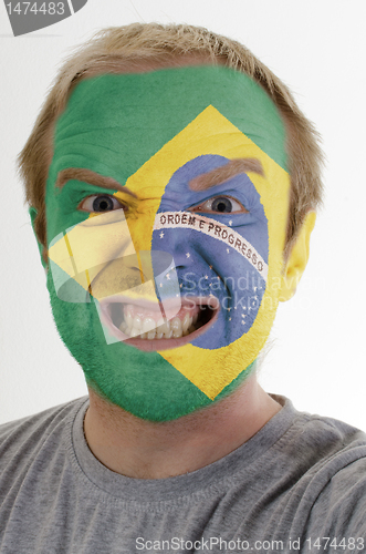 Image of Face of crazy angry man painted in colors of brazil flag