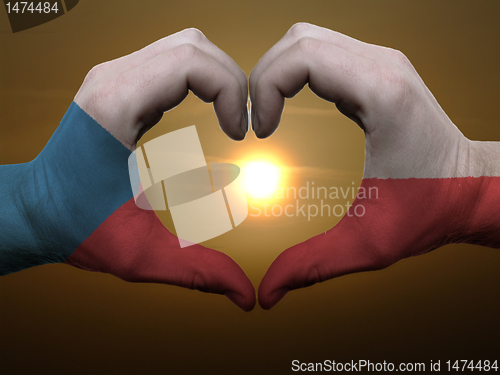 Image of Heart and love gesture by hands colored in czech flag during bea