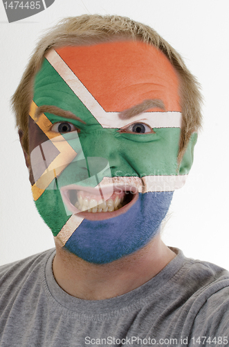 Image of Face of crazy angry man painted in colors of south africa flag