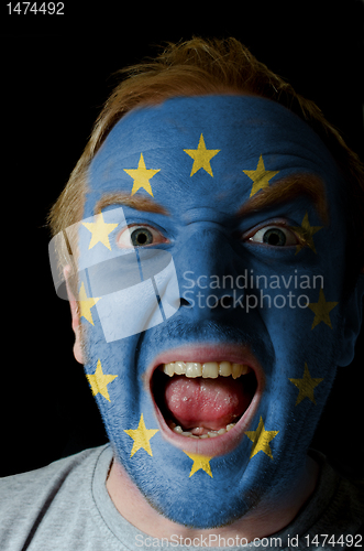 Image of Face of crazy angry man painted in colors of europe flag