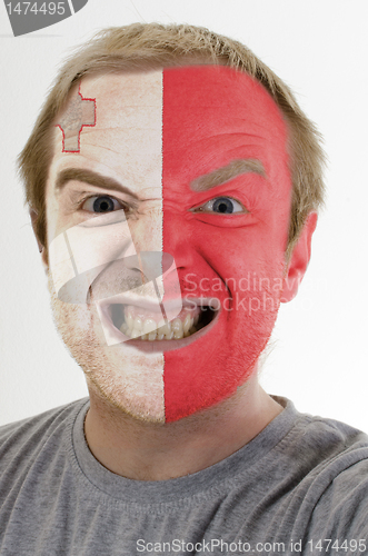 Image of Face of crazy angry man painted in colors of malta flag