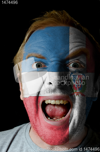 Image of Face of crazy angry man painted in colors of dominican flag