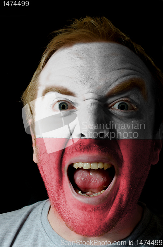 Image of Face of crazy angry man painted in colors of poland flag