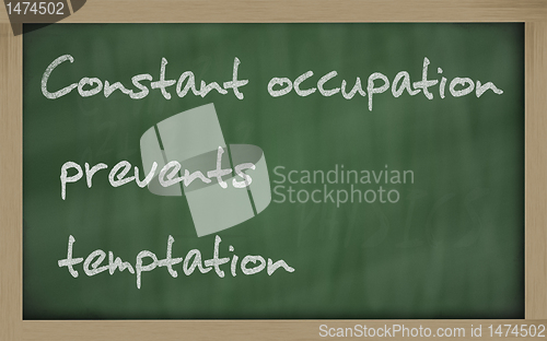 Image of " Constant occupation prevents temptation " written on a blackbo