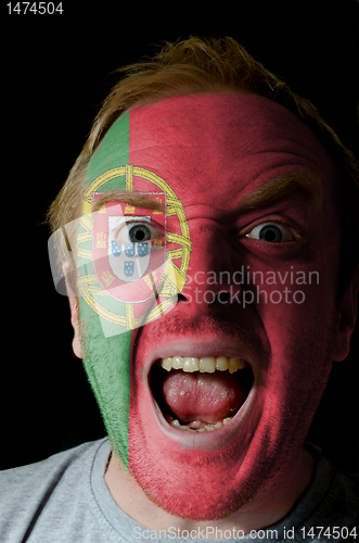 Image of Face of crazy angry man painted in colors of portugal flag