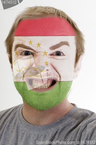 Image of Face of crazy angry man painted in colors of Tajikistan flag