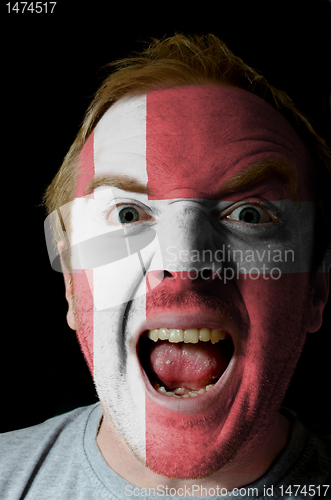 Image of Face of crazy angry man painted in colors of denmark flag