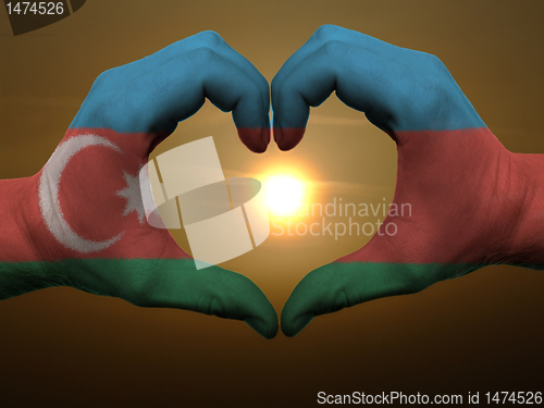 Image of Heart and love gesture by hands colored in azerbaijan flag durin