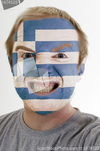 Image of Face of crazy angry man painted in colors of greece flag