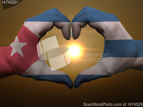 Image of Heart and love gesture by hands colored in cuba flag during beau