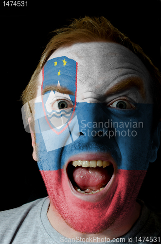 Image of Face of crazy angry man painted in colors of slovenia flag