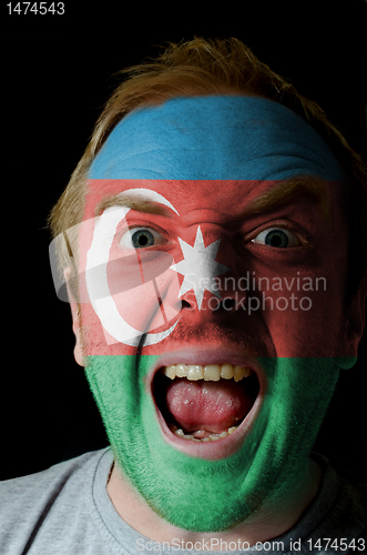 Image of Face of crazy angry man painted in colors of azerbaijan flag