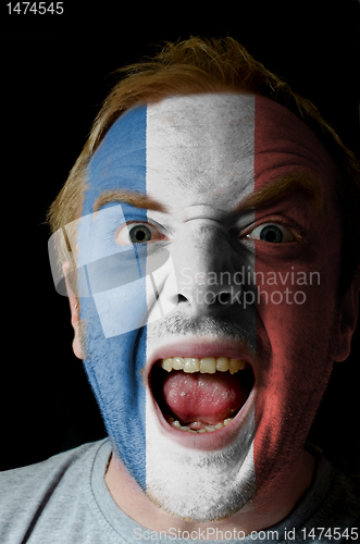 Image of Face of crazy angry man painted in colors of france flag