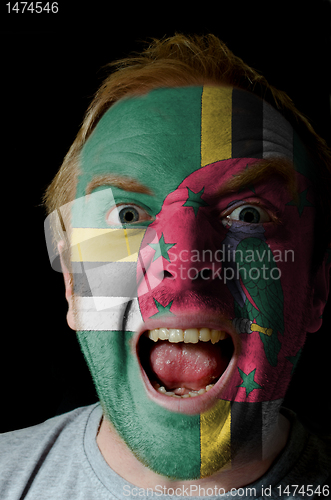 Image of Face of crazy angry man painted in colors of dominica flag