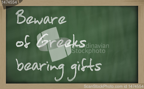 Image of "   Beware of Greeks bearing gifts " written on a blackboard