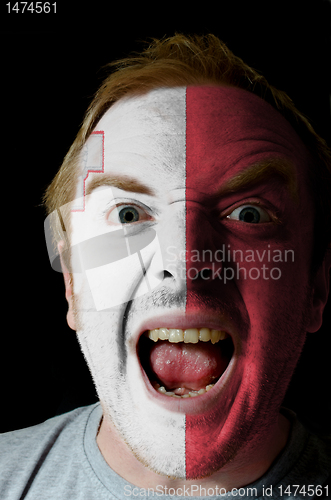 Image of Face of crazy angry man painted in colors of malta flag