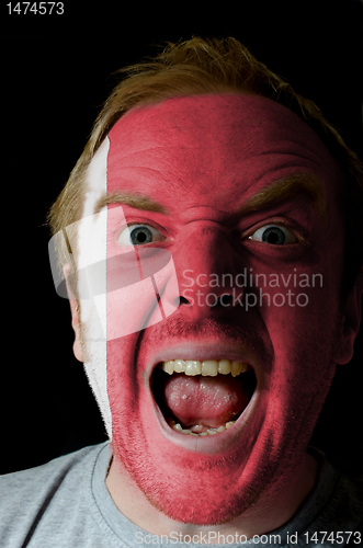 Image of Face of crazy angry man painted in colors of Bahrain flag