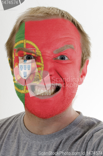 Image of Face of crazy angry man painted in colors of portugal flag