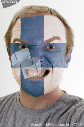 Image of Face of crazy angry man painted in colors of finland flag