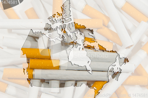 Image of Map of Canada with cigarettes in background