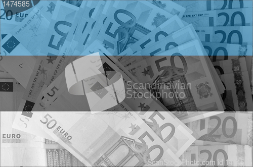 Image of flag of Estonia with transparent euro banknotes in background 