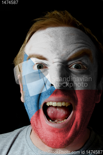 Image of Face of crazy angry man painted in colors of czech flag