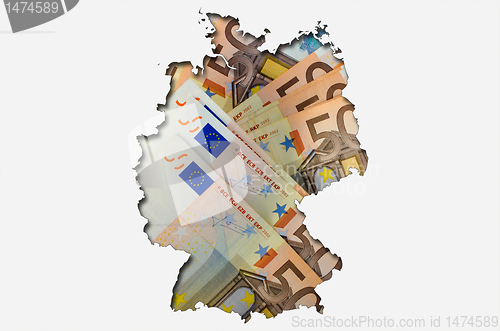 Image of Outline map of Germany with euro banknotes in background 