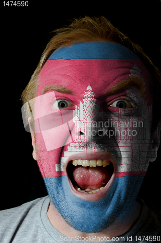 Image of Face of crazy angry man painted in colors of Cambodia flag