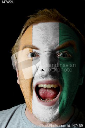 Image of Face of crazy angry man painted in colors of Cote'd Ivore flag