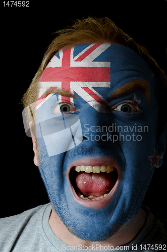 Image of Face of crazy angry man painted in colors of new zealand flag