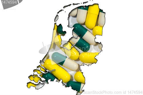 Image of Outline map of Netherlands with pills in background