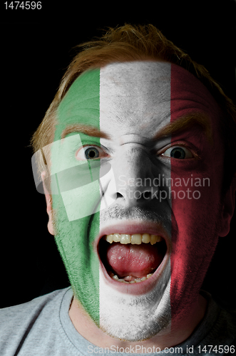 Image of Face of crazy angry man painted in colors of italy flag