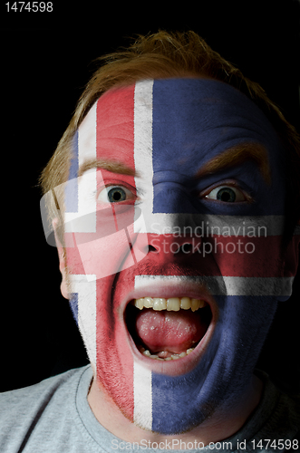 Image of Face of crazy angry man painted in colors of iceland flag