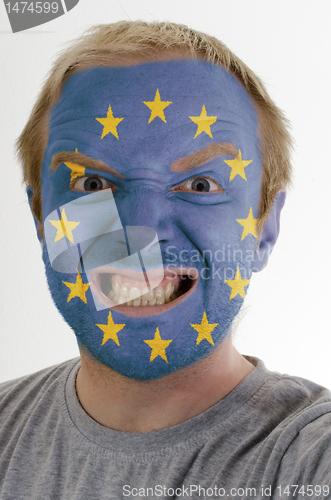 Image of Face of crazy angry man painted in colors of europe flag
