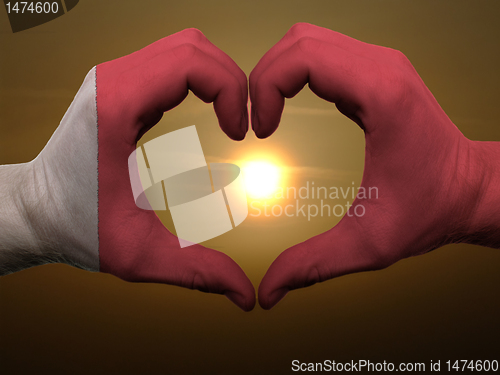 Image of Heart and love gesture by hands colored in bahrain flag during b
