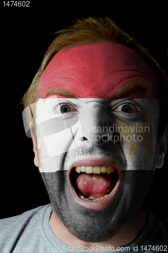 Image of Face of crazy angry man painted in colors of egypt flag