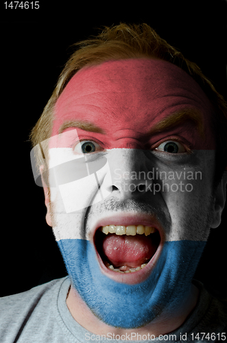 Image of Face of crazy angry man painted in colors of holland flag