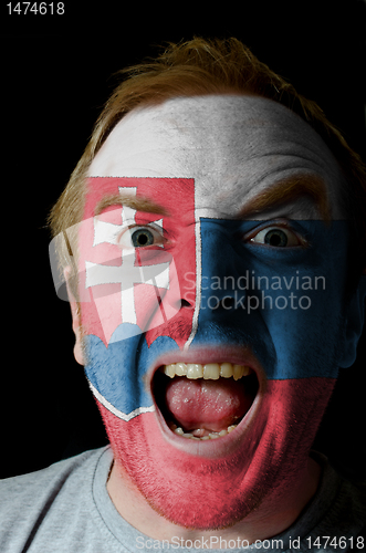 Image of Face of crazy angry man painted in colors of slovakia flag