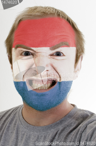 Image of Face of crazy angry man painted in colors of holland flag