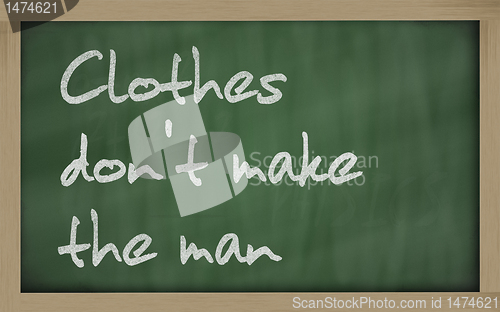 Image of " Clothes don't make the man " written on a blackboard