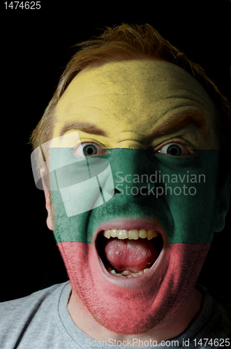 Image of Face of crazy angry man painted in colors of lithuania flag