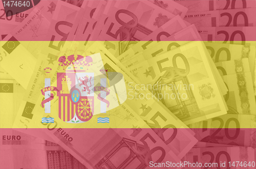 Image of flag of Spain with transparent euro banknotes in background 