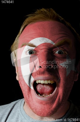 Image of Face of crazy angry man painted in colors of turkey flag