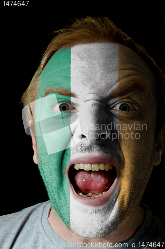 Image of Face of crazy angry man painted in colors of ireland flag