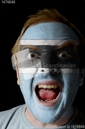 Image of Face of crazy angry man painted in colors of Botswana flag