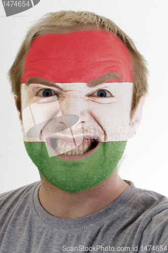 Image of Face of crazy angry man painted in colors of hungary flag