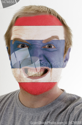 Image of Face of crazy angry man painted in colors of Thailand flag