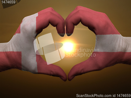 Image of Heart and love gesture by hands colored in denmark flag during b