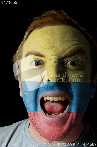 Image of Face of crazy angry man painted in colors of Columbia flag